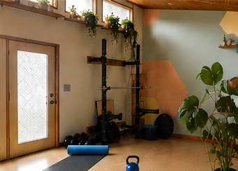 Wood-framed glass door beside the rack, with plants along the windows.